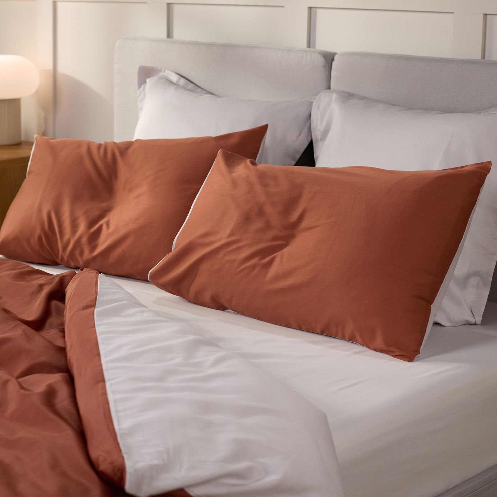 Dekoriertes Schlafzimmer mit Fokus auf dem Bett und passender Bettwäsche