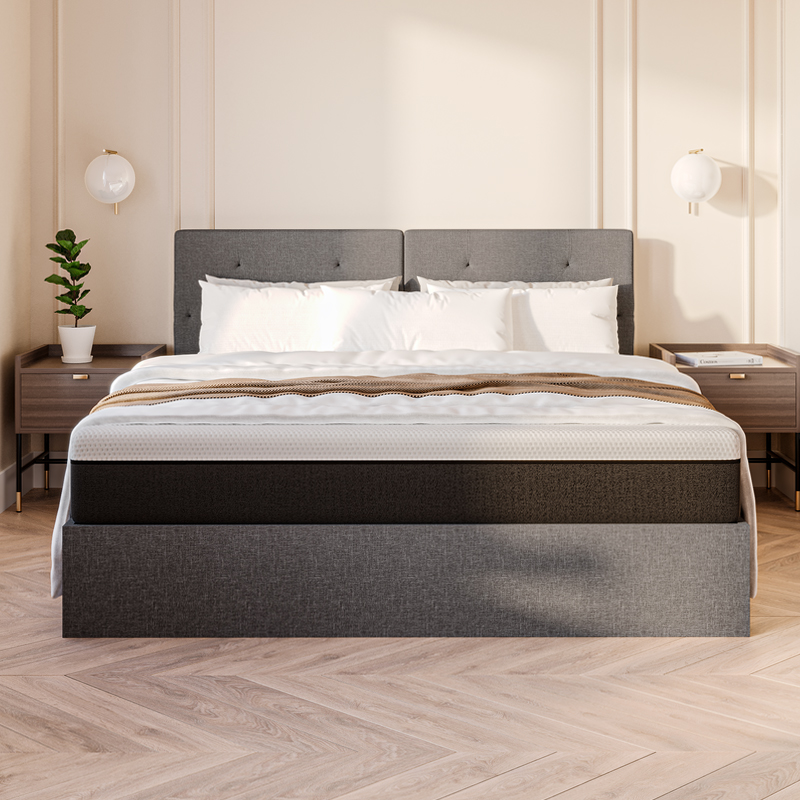 Grey upholstered storage bed with white bedding.