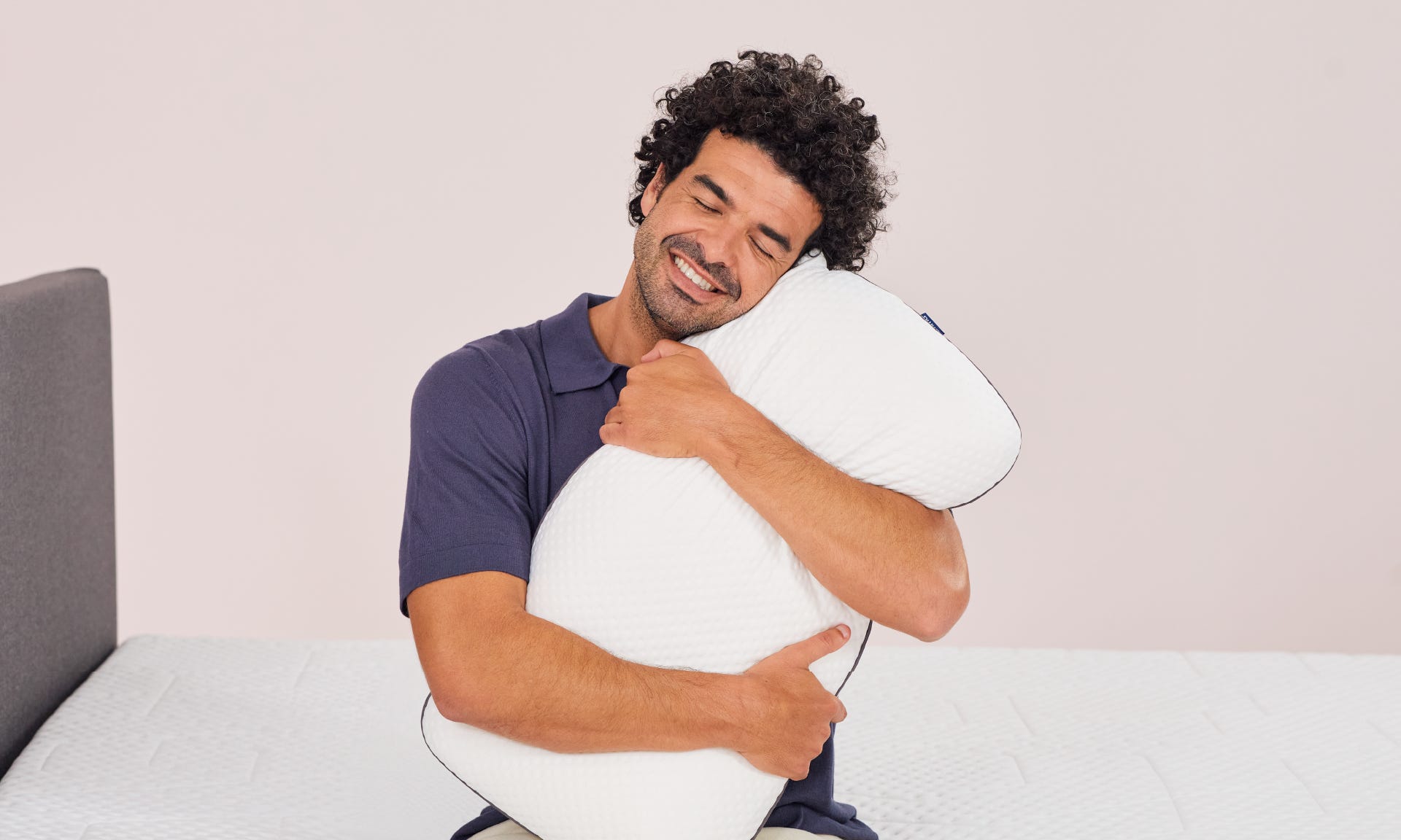 Man hugging emma pillow