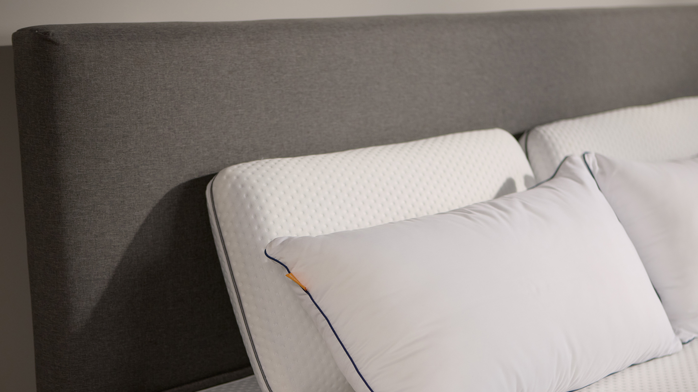 Close-up of the Emma Boxspring Bed in dark grey showing the upholstered headboard corner with an Emma pillow.You said: cannot see this chat
