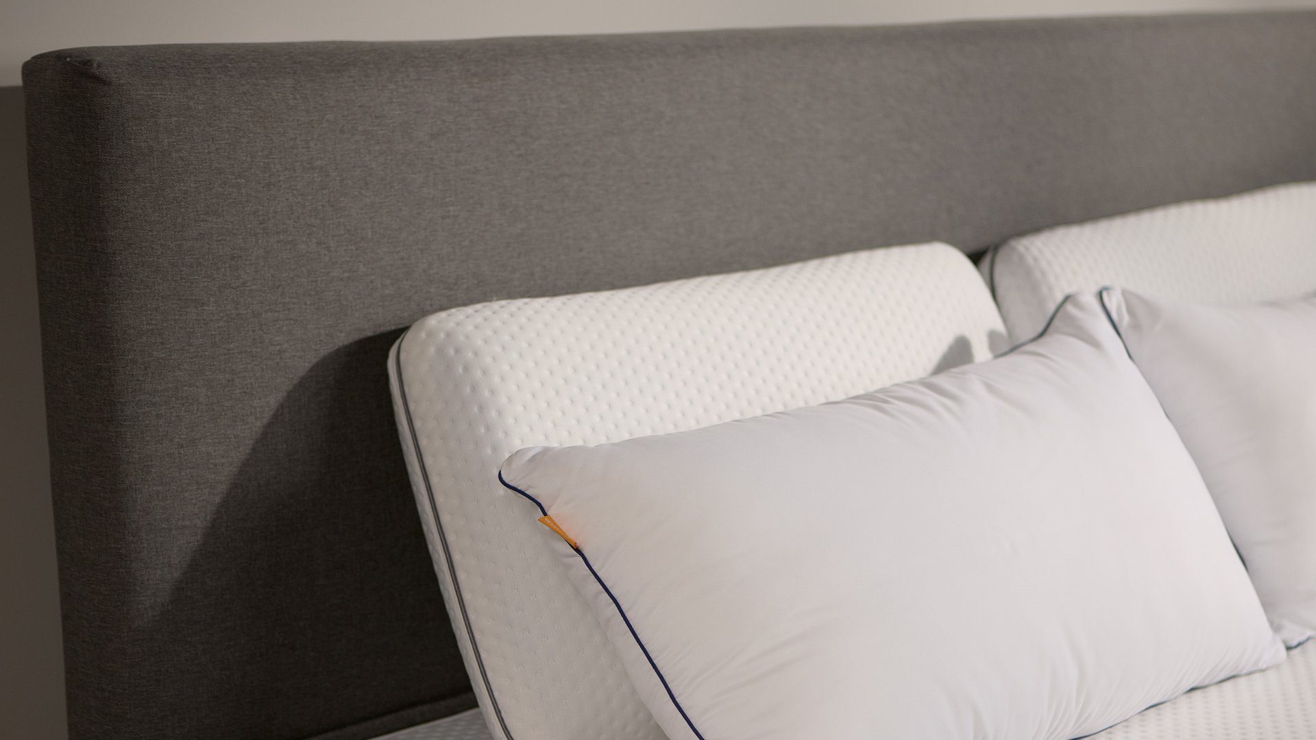 Close-up of the Emma Boxspring Bed in dark grey showing the upholstered headboard corner with an Emma pillow.You said: cannot see this chat