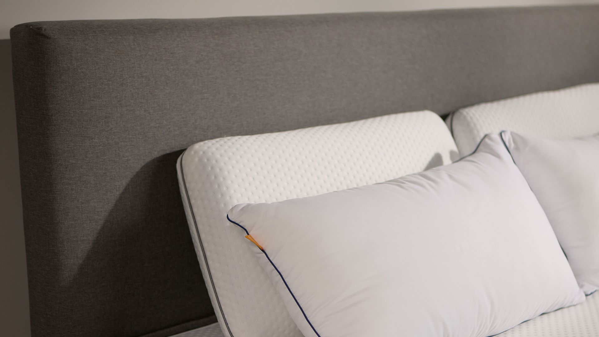 Close-up of the Emma Boxspring Bed in dark grey showing the upholstered headboard corner with an Emma pillow.You said: cannot see this chat