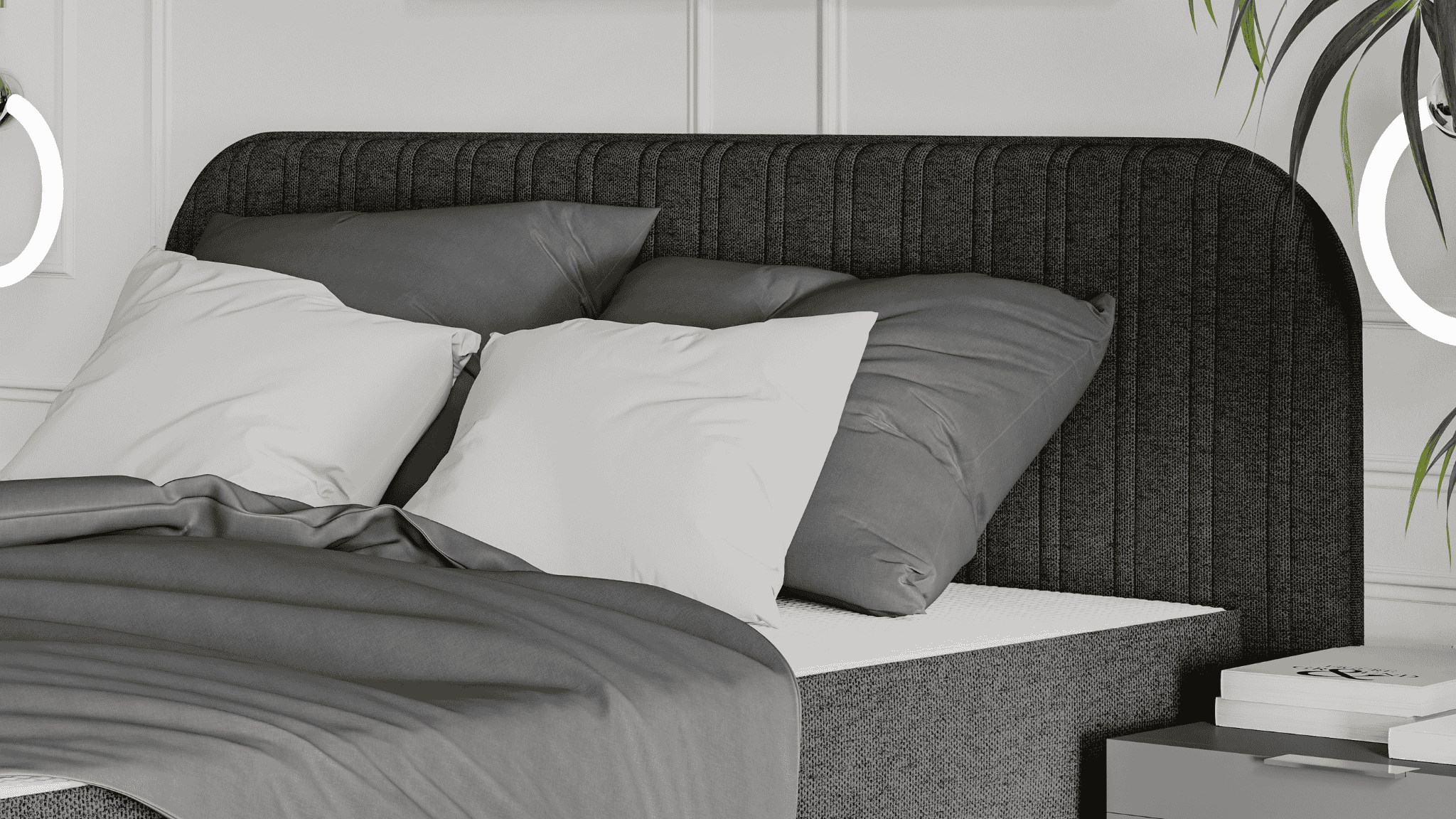 Moderne slaapkamer met donkere Emma Signature Boxspring, verticale stikdetails op het hoofdbord, grijze en witte lakens, en minimalistische verlichting aan de wand.