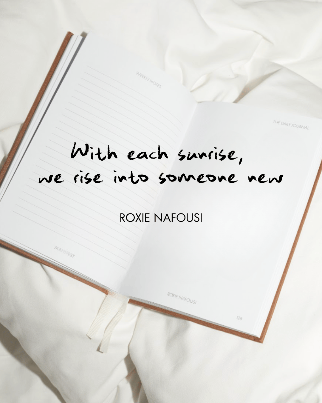 An open book with the sentence "With each sunrise, we rise into someone new - Roxie Nafousi".