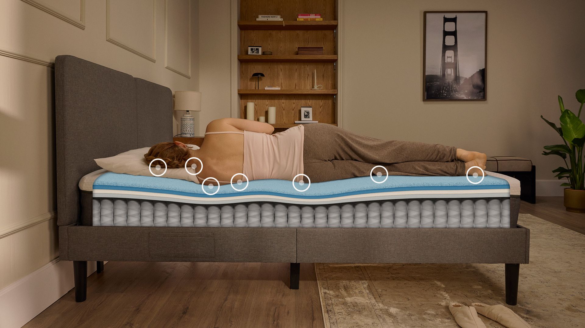 Person lying on their side on a white mattress in a relaxed sleeping position.