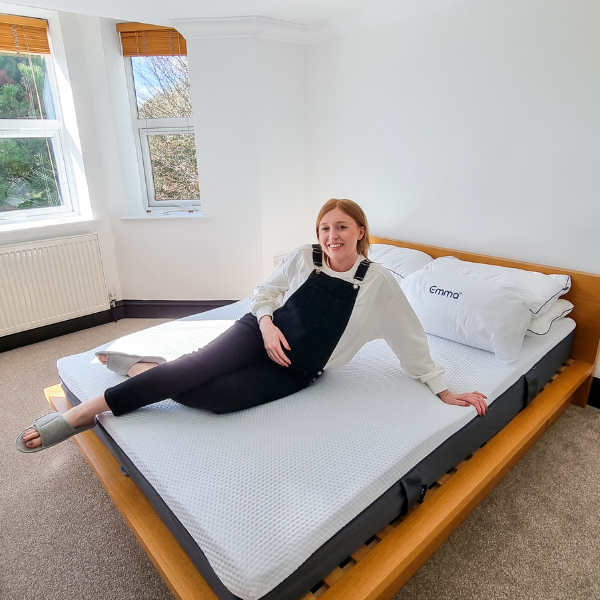 Pregnant woman laying on an Emma mattress.