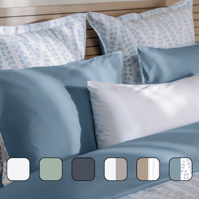 Image en gros plan d’un lit avec des oreillers et une housse de couette.