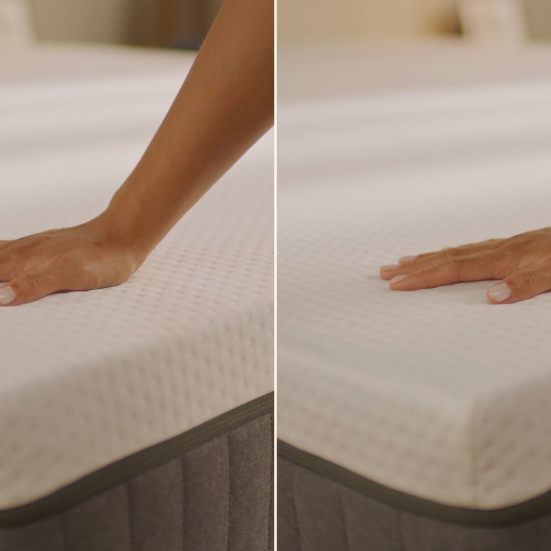 Person pressing the mattress surface to show its feel.