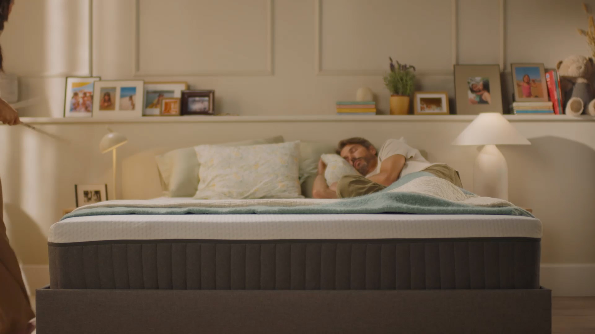 Person resting on a bed with a white mattress, showing undisturbed comfort.