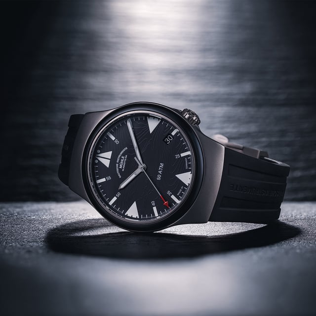 Mühle-Glashütte S.A.R. Mission-Timer “160 Years of DGzRS”, titanium watch with black dial laying on a dark surface
