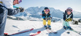 Drei Personen auf Ski im Skigebiet Carezza Dolomites.