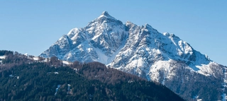 Schneebedeckter Berg bei blauem Himmel in Tirol.