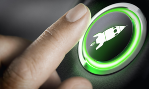 Man finger pressing an boost button with a rocket icon, black background and green light. Composite between a photography and a 3D background. Start-u
