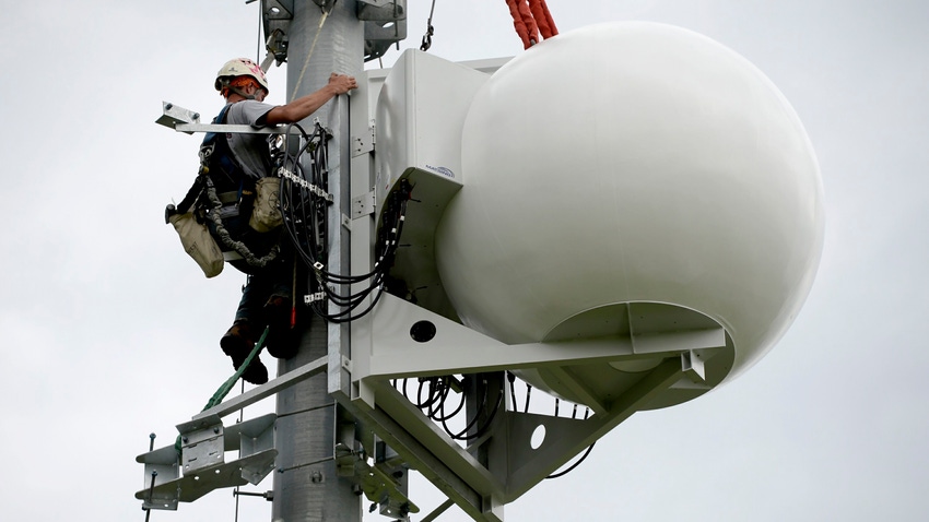 Verizon cell tower with technician