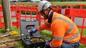 Openreach engineer at work in a field Openreach engineer at work in a field