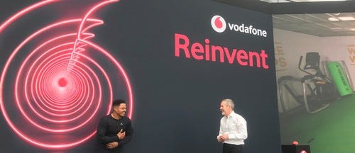 South African rugby star Juan de Jongh (left) feels the impact of a tackle on a training bag 100 miles away, while Scott Petty, Vodafone UK's chief technology officer, looks on.