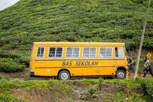 A school bus on along a hilly road in Penang, Malaysia