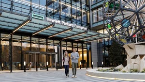 Two people walk outside HPE's Houston headquarters
