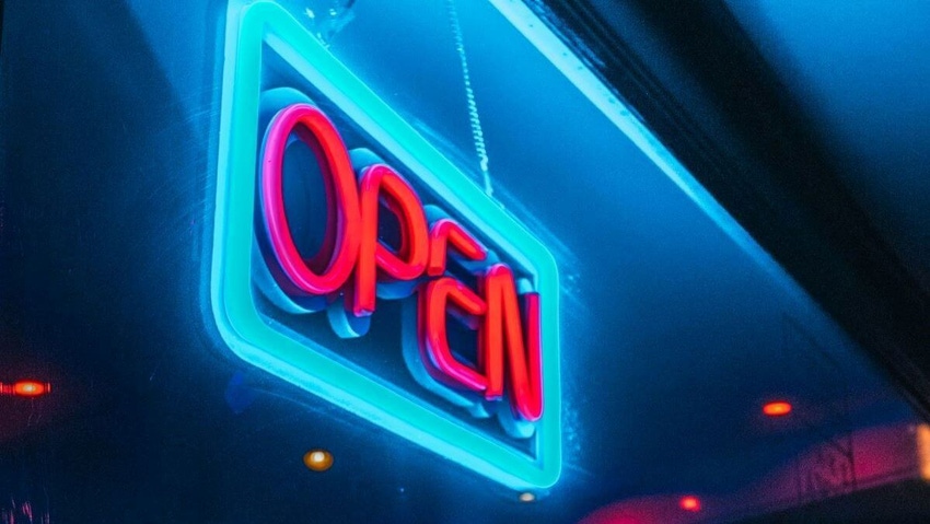 Neon sign saying 'open' in red letters, with a blue frame and blue and black background.