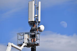 Man working on mobile tower antenna mast