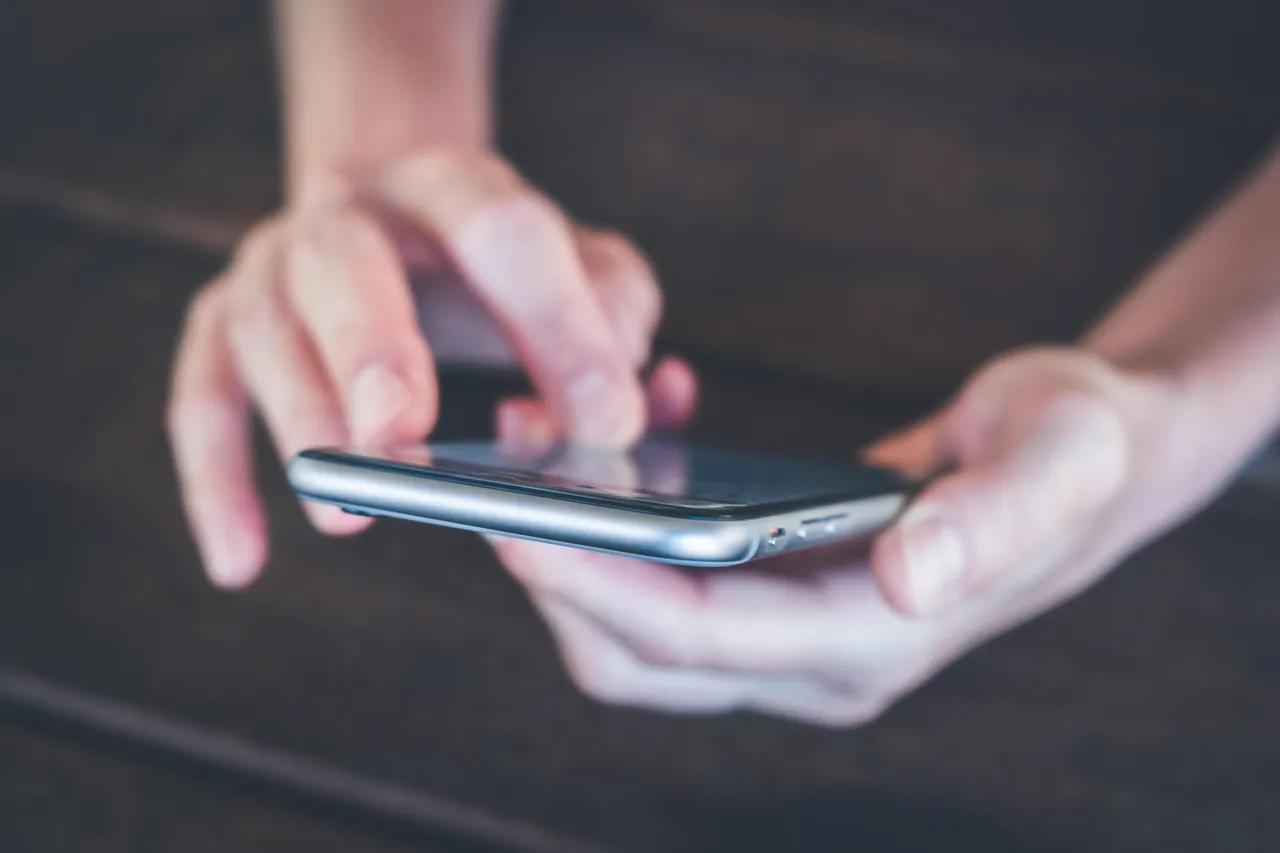 hands holding smartphone closeup hands holding smartphone closeup