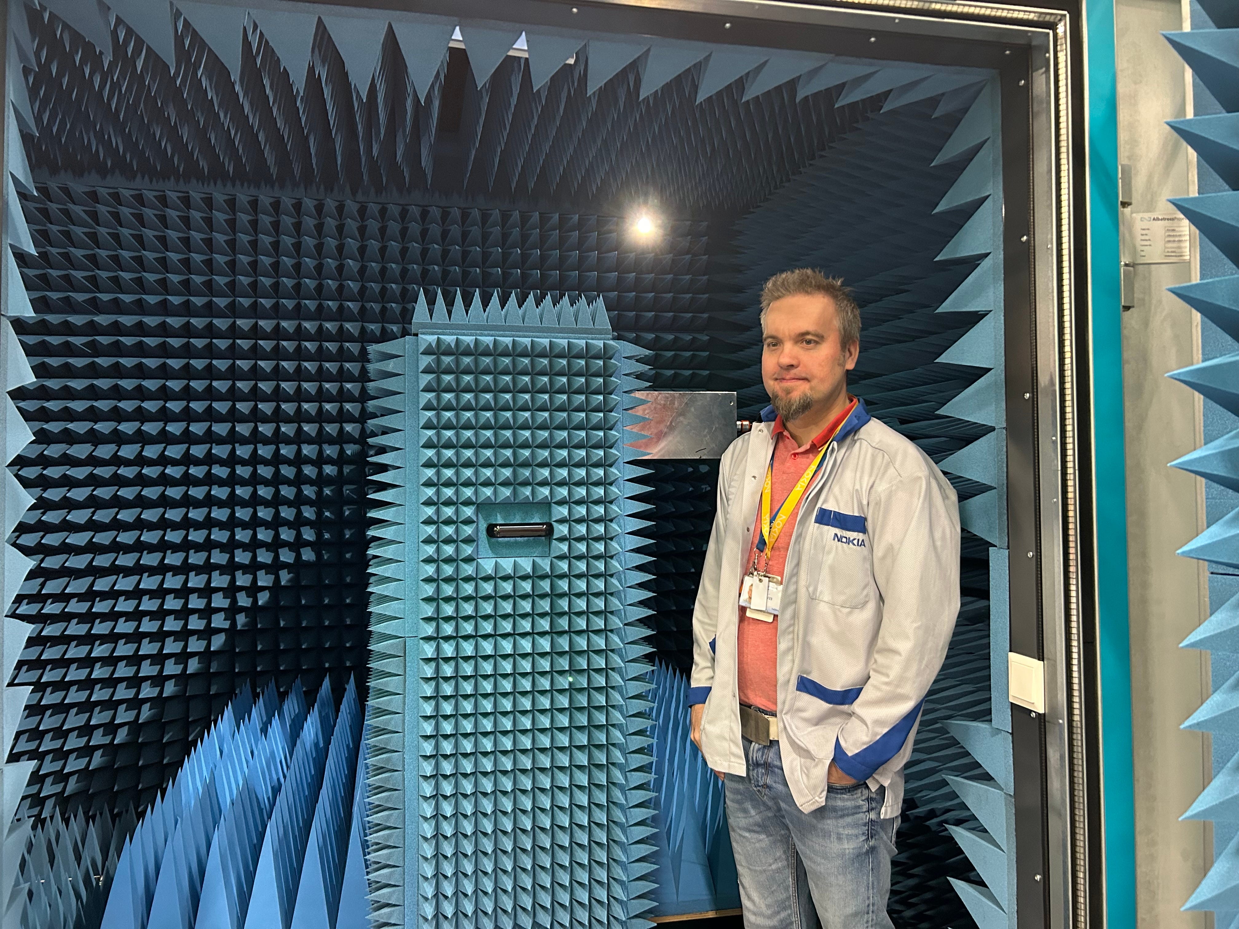 Nokia employee stands inside an anechoic chamber