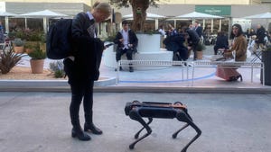 Woman next to robot dog at MWC 2023