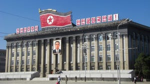Large municipal building in North Korea, with North Korean flag