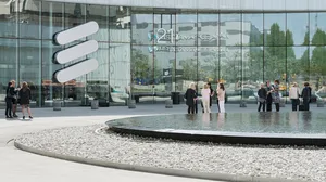 Ericsson headquarters front entrance with people gathered Ericsson headquarters front entrance with people gathered