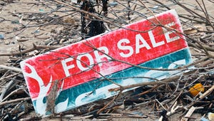'For sale' sign lying on the ground
