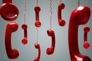 Red landline phones hanging from above on a grey background.