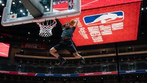 Basketball player in flight underneath a Rakuten logo