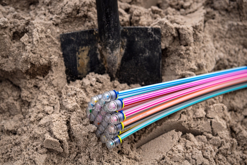 Fiber optic cables in the ground at a construction site.