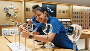 Apple store Mumbai team member with Apple Watch lineup