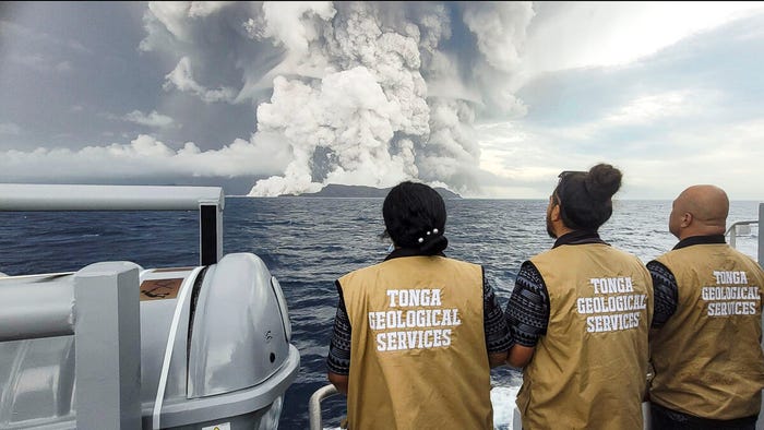 Tonga Geological Services staff observe and monitor the eruption of Hunga Tonga Hunga Ha'apai on January 13th from a safe distance. (Source: ZUMA Press, Inc./Alamy Stock Photo)