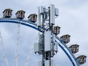  5G cell tower stands in front of a Ferris wheel at Oktoberfest grounds