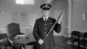 Policeman holding canes for corporal punishment