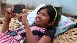 Indian girl relaxing with smartphone