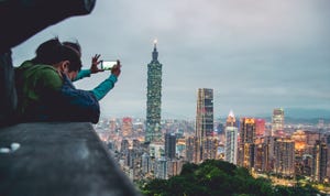 A person taking a photo with their smartphone in Taiwan