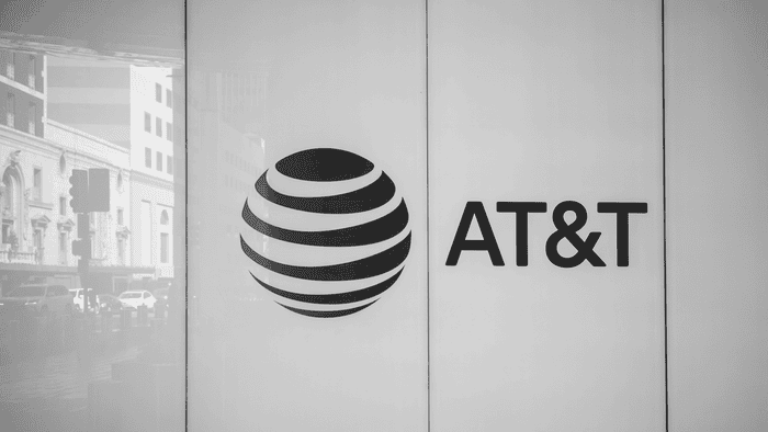 The AT&T logo at the company's Dallas headquarters building. The reflection shows the traffic piling up on Commerce Street. (Source: Phil Harvey/Light Reading) 