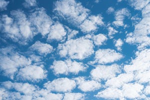 Multiple clouds on blue sunny sky background