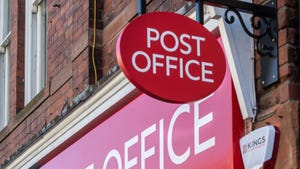 Post Office sign hanging above a branch