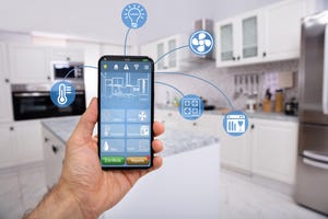 Hand Holding smartphone using a smart home system.