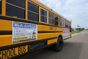 School buses equipped with wi-fi park along the streets of Colonia El Cenizo, Texas 