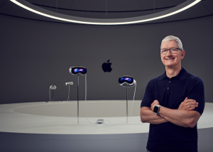 Apple CEO Tim Cook standing in front of headsets.