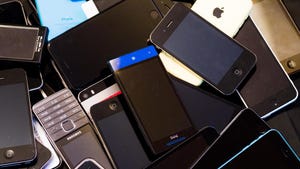 Smartphones from different brands in a pile.