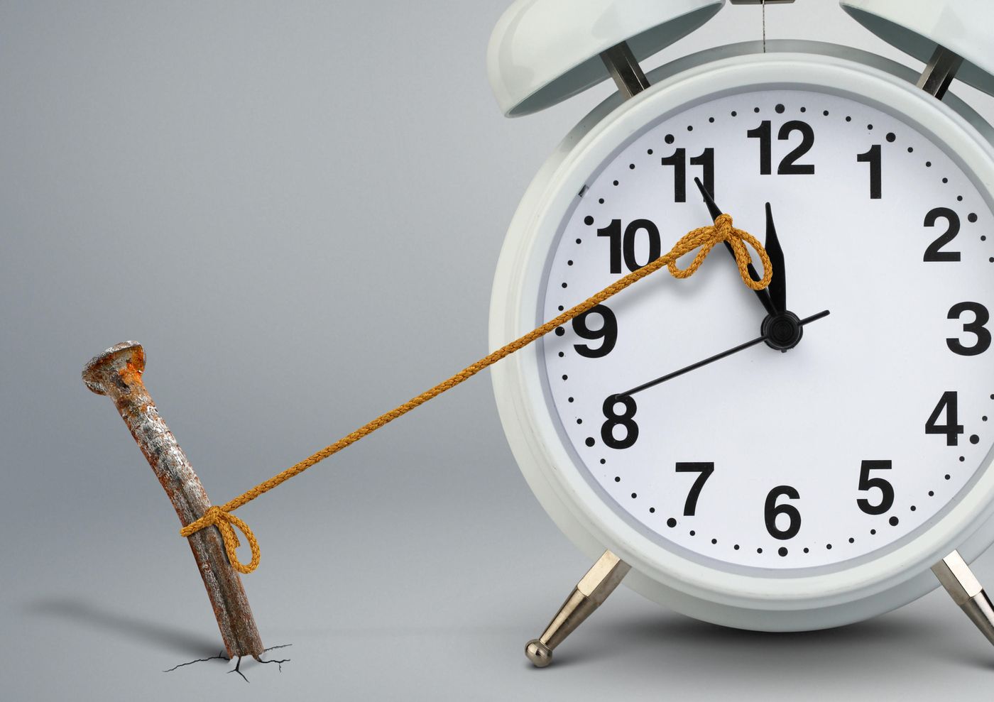 Time on clock stopped by a nail attached with rope Time on clock stopped by a nail attached with rope