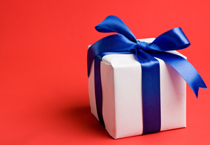 white gift with a blue ribbon on a red background