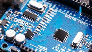 Semiconductor microchip on blue circuit board