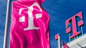 Deutsche Telekom logo on top of their building and flag with their logo to the left